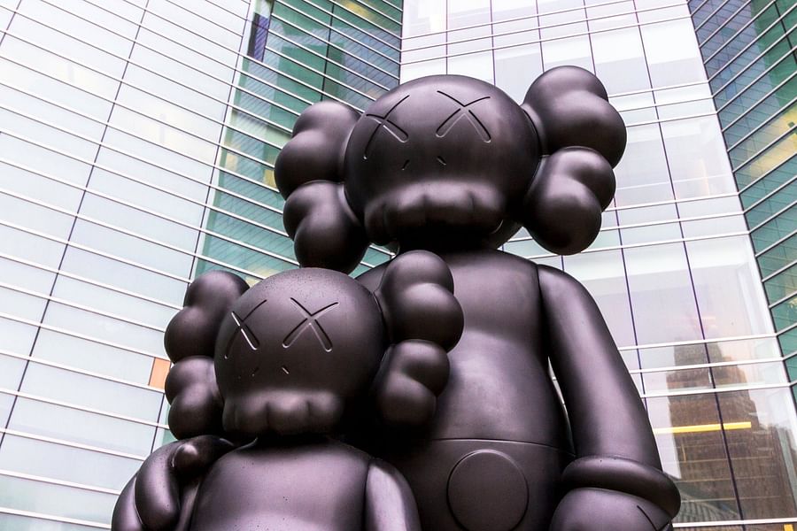 People wearing streetwear featuring iconic Kaws symbols